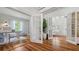 Bright office space featuring an desk and chair, hardwood floors, and glass french doors that provide seamless transition to other rooms at 7715 Westmoreland Dr, Sarasota, FL 34243