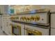Close up of a luxurious designer gas range with gold accents, brass knobs, and double oven at 7715 Westmoreland Dr, Sarasota, FL 34243