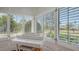 Sitting room featuring large shuttered windows and a white baby grand piano at 7715 Westmoreland Dr, Sarasota, FL 34243