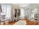 Well organized walk-in closet featuring a clothing rack, decorative mirror, decorative chair, and a window with a curtain at 7715 Westmoreland Dr, Sarasota, FL 34243