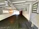 Basement featuring painted black flooring, exposed rafter ceiling, and a red door in the back at 8219 Drew St, Englewood, FL 34224