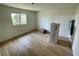 This bedroom features freshly installed wood look flooring, a window, and blank white walls at 8219 Drew St, Englewood, FL 34224