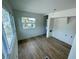 Bright bedroom with light walls, wood flooring, and view to the outdoors at 8219 Drew St, Englewood, FL 34224