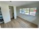 Bright bedroom features wood flooring, view to the outdoors, and adjacent sink area at 8219 Drew St, Englewood, FL 34224