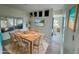 Dining room features wood floors and adjacent sunroom view at 8219 Drew St, Englewood, FL 34224