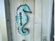 Unique seahorse-shaped address plaque, adding coastal charm to the property at 8219 Drew St, Englewood, FL 34224