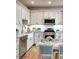 Updated kitchen features white cabinetry, stainless steel appliances, and breakfast nook at 8219 Drew St, Englewood, FL 34224