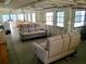 Sitting area featuring exposed rafters and concrete flooring and gray sofa at 8219 Drew St, Englewood, FL 34224