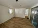 Bright living room with wood flooring and view to hallway and sliding doors at 8219 Drew St, Englewood, FL 34224