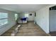 Bright living room with new floors and plenty of natural light from two windows at 8219 Drew St, Englewood, FL 34224