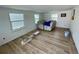 Bright living room with new floors and plenty of natural light from two windows at 8219 Drew St, Englewood, FL 34224