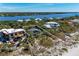 Aerial view of a vacant lot outlined in white, showcasing waterfront property and lush foliage at 8270 Manasota Key Rd, Englewood, FL 34223