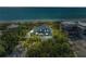Aerial view of a home surrounded by lush landscaping, near the ocean, showcasing its serene setting at 8270 Manasota Key Rd, Englewood, FL 34223
