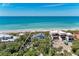 Aerial view of a beachfront property near new construction and lush tropical greenery at 8270 Manasota Key Rd, Englewood, FL 34223