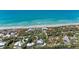 Breathtaking aerial view showcasing a beachfront property surrounded by tropical landscape at 8270 Manasota Key Rd, Englewood, FL 34223