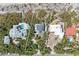 Aerial view of a vacant lot outlined in white, showcasing the property layout and surrounding homes at 8270 Manasota Key Rd, Englewood, FL 34223