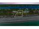 Aerial view of a vacant lot outlined in white, with beach proximity and intercoastal waterway at 8270 Manasota Key Rd, Englewood, FL 34223