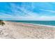 Expansive sandy beach with clear blue waters, perfect for swimming, sunbathing, and relaxing at 8270 Manasota Key Rd, Englewood, FL 34223