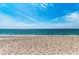 Tranquil beach scene with soft sand and turquoise waters under a bright blue sky at 8270 Manasota Key Rd, Englewood, FL 34223