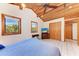 Bedroom featuring high vaulted ceilings, wood paneling, two windows and tile flooring at 8270 Manasota Key Rd, Englewood, FL 34223