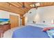 Bedroom with high ceilings, wood paneling, tile floors, and open closet at 8270 Manasota Key Rd, Englewood, FL 34223