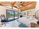 Bedroom boasts vaulted wood ceilings and sliding glass door to a screened patio with ocean views at 8270 Manasota Key Rd, Englewood, FL 34223