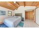 Bedroom features wood ceilings, tile floors, a window, and access to the hallway at 8270 Manasota Key Rd, Englewood, FL 34223