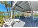 Relaxing covered patio with seating, offering shade and views of the beach and ocean at 8270 Manasota Key Rd, Englewood, FL 34223