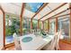 Bright sunroom dining area with views of the private yard at 8270 Manasota Key Rd, Englewood, FL 34223