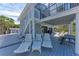 Outdoor deck with lounge chairs and picnic table, perfect for relaxation and entertaining near the beach at 8270 Manasota Key Rd, Englewood, FL 34223
