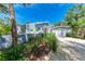 Lovely coastal home with a manicured lawn, spacious driveway, and attached garage at 8270 Manasota Key Rd, Englewood, FL 34223