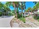 Beachside home with mature palm trees, showcasing a basketball hoop and sandy landscaping at 8270 Manasota Key Rd, Englewood, FL 34223