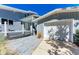 Inviting coastal home with a well-maintained garage and beautifully landscaped walkway at 8270 Manasota Key Rd, Englewood, FL 34223