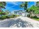 Charming coastal home featuring a spacious driveway and beautifully landscaped front yard at 8270 Manasota Key Rd, Englewood, FL 34223