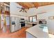 Modern kitchen with stainless steel appliances, ample counter space, and wood-beamed ceilings at 8270 Manasota Key Rd, Englewood, FL 34223