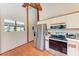 Bright kitchen with stainless steel appliances, tile floors, and a view of the sea at 8270 Manasota Key Rd, Englewood, FL 34223