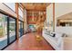 Bright, open living room with high ceilings, tile floors, and a spiral staircase at 8270 Manasota Key Rd, Englewood, FL 34223