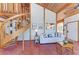 Charming living room with unique spiral staircase, tile floors, and natural light at 8270 Manasota Key Rd, Englewood, FL 34223