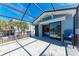 Bright screened patio with tile flooring and an entrance to the bedroom through glass sliding doors at 8270 Manasota Key Rd, Englewood, FL 34223