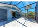 Bright screened patio with tile flooring and a glimpse of the bedroom through the glass sliding doors at 8270 Manasota Key Rd, Englewood, FL 34223