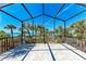 Expansive screened-in patio featuring amazing ocean views through the palms at 8270 Manasota Key Rd, Englewood, FL 34223