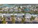 Aerial view of complex and surrounding neighborhood, featuring condos, parking, boat docks, and waterways at 902 Gibbs Rd # 282, Venice, FL 34285
