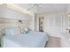 Bright bedroom with white cabinets and shelves for storage, a ceiling fan, and an ensuite bathroom at 902 Gibbs Rd # 282, Venice, FL 34285