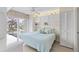 Bright bedroom with a view to the outside, white cabinets and shelves for storage, and a ceiling fan at 902 Gibbs Rd # 282, Venice, FL 34285