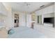 Bright bedroom with white cabinets and drawers for storage, a ceiling fan, and an ensuite bathroom at 902 Gibbs Rd # 282, Venice, FL 34285