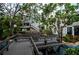 Wooden walkway with 'Bahia Vista Gulf' sign surrounded by lush greenery and glimpses of the building at 902 Gibbs Rd # 282, Venice, FL 34285