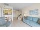 Bright living room with open layout, tile floors, and views into the adjacent kitchen area at 902 Gibbs Rd # 282, Venice, FL 34285