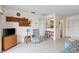 Comfortable living room with an ornate bookshelf, flatscreen television, and views into the kitchen at 902 Gibbs Rd # 282, Venice, FL 34285