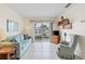 Inviting living room with tile flooring, neutral walls, and sliding doors to a canal view at 902 Gibbs Rd # 282, Venice, FL 34285