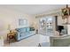 Comfortable living room featuring sliding glass doors with canal views and neutral decor at 902 Gibbs Rd # 282, Venice, FL 34285